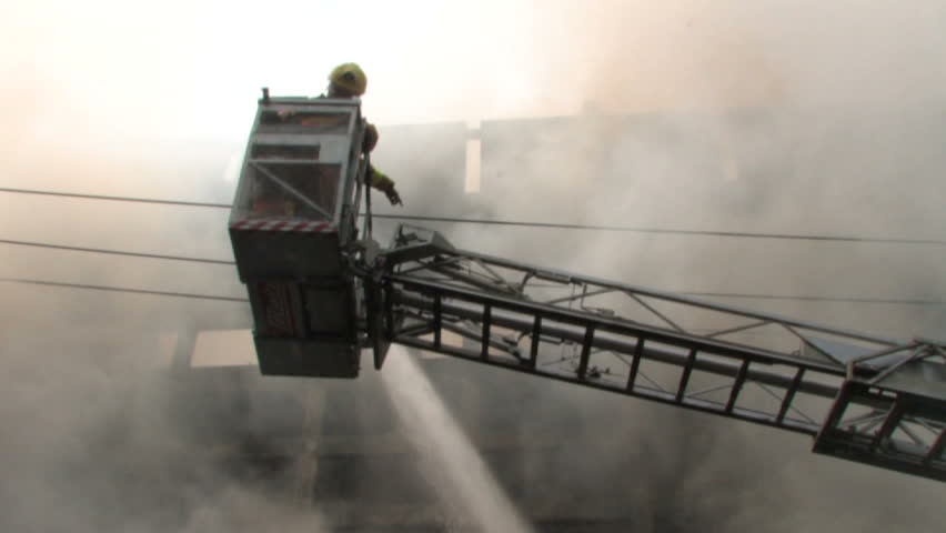 BANGKOK, THAILAND - April 19, 2010: Firemen battle blazes across the city after protesters set more than 40 buildings on fire during a government crackdown 