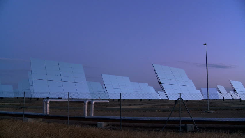 Time-lapse of solar energy panels moving to produce environmentally clean power