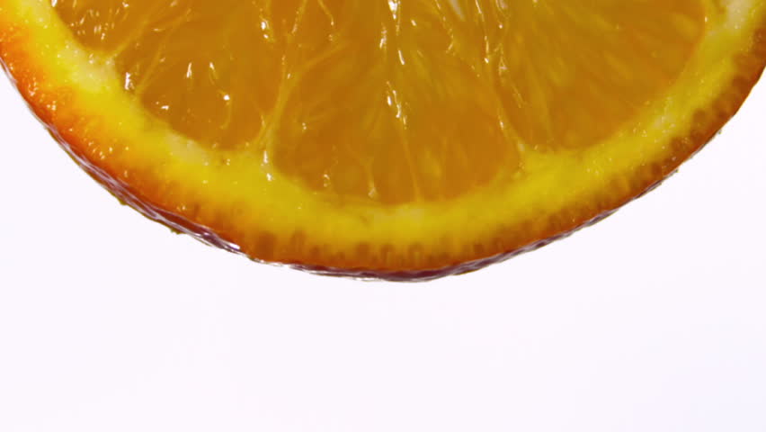 Fresh fruit and vegetables float through water in slow motion. 