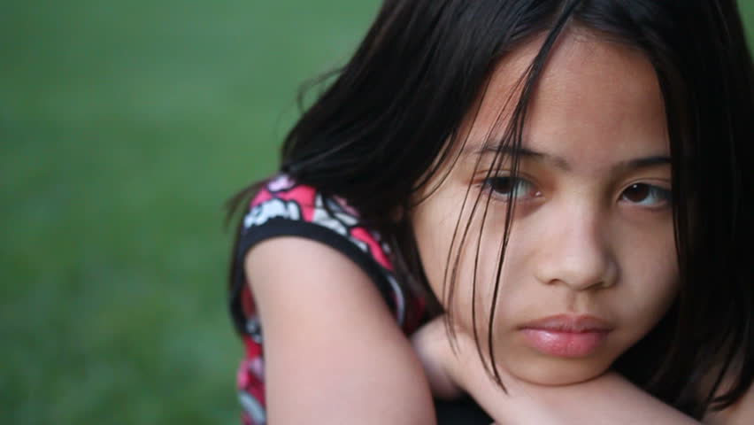 a close-up shot of a young Asian girl showing different emotions