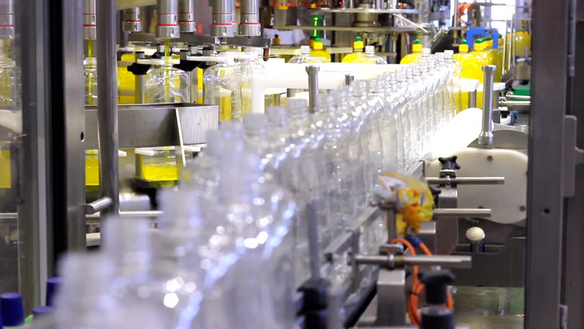 Bottle Filling Machine. - Dishwashing Detergent.
Empty bottles move along the conveyor belt  to the filling machine.The piston filling heads deliver liquid detergent into the bottles.