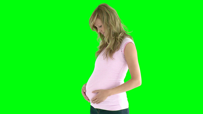 young expectant mom standing against green screen