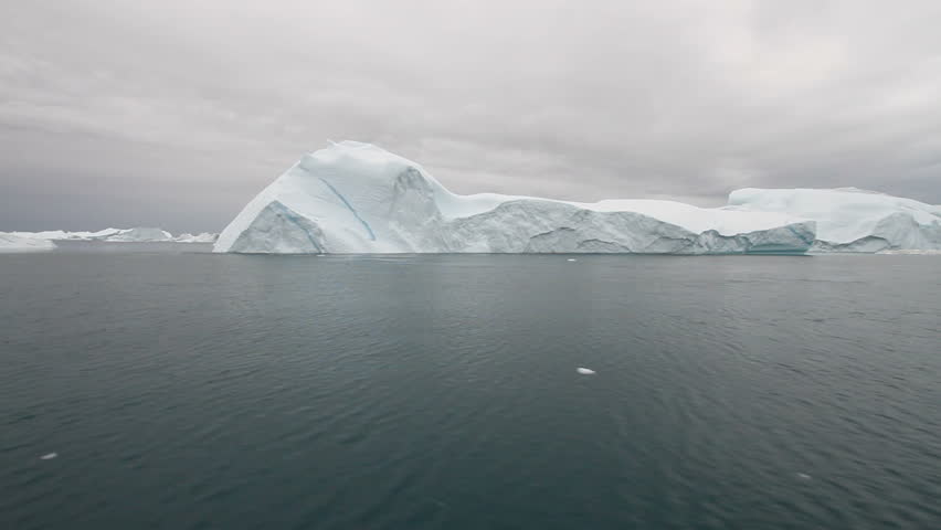 Sailing by an iceberg in the famous Ilulissat icefjord in Greenland. The icefjord is on UNESCO's World Heritage List.