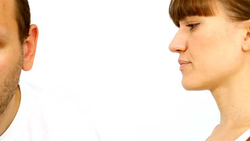 Portrait of woman whispering in man's ear 