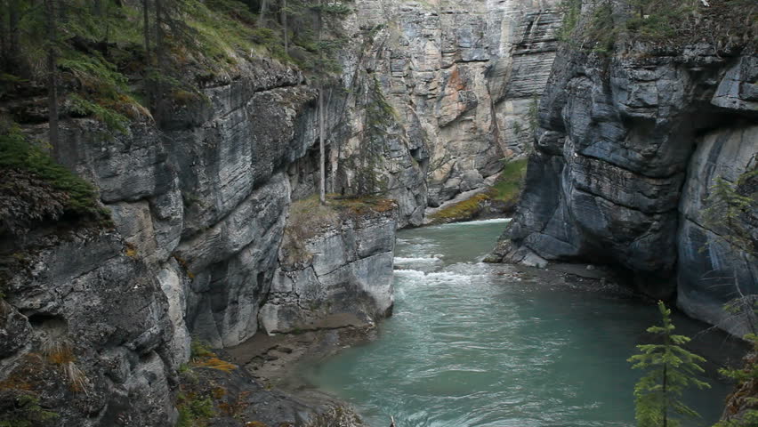 River gorge and flowing river at Maligne Canyon, Banff National Park, Alberta, Canada. Rushing water through narrow gorge created by the forces of water. Popular vacation and naturalist destination.