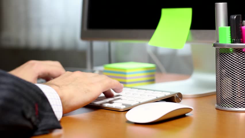 HD: Businessman typing on computer keyboard at office