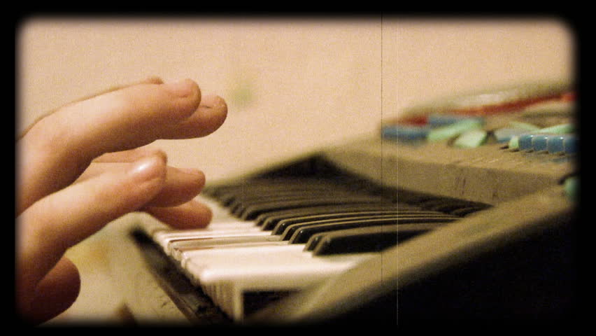 little girl plays toy piano 16mm "film" look. 