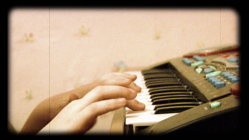 little girl plays toy piano 16mm "film" look. 