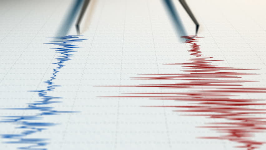 Close view of a seismograph with two arrows drawing with red and blue ink. 