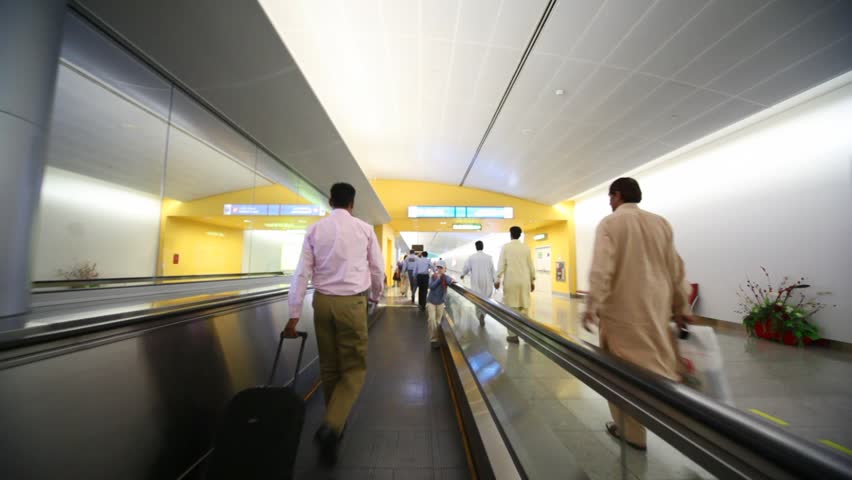 DUBAI - APRIL 13: People on travelator or moving walkway in Dubai International Airport on April 13 2010. The airport was the 15th busiest airport in the world by passenger traffic handling 40.9 million passengers in 2009. 