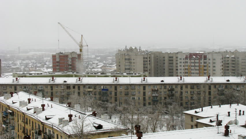 Time lapse of cityscape with falling snow