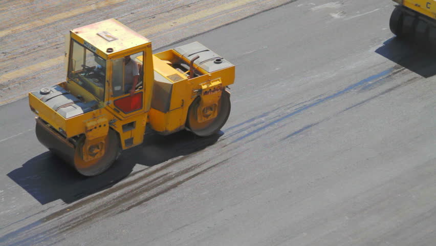 Vibratory Asphalt Compactor and Pneumatic Asphalt Compactor flattening asphalt