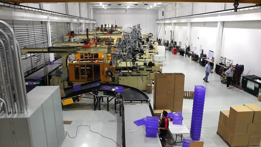 A wide shot of an entire robotics assembly plant in motion. 