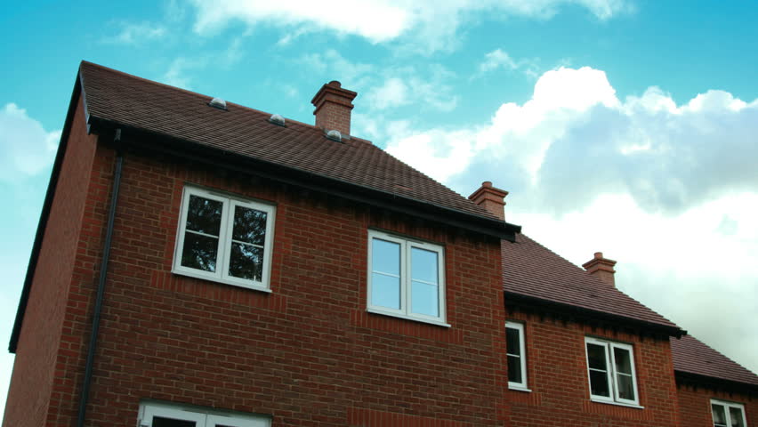 time lapse of terrace houses against a blue sunny sky