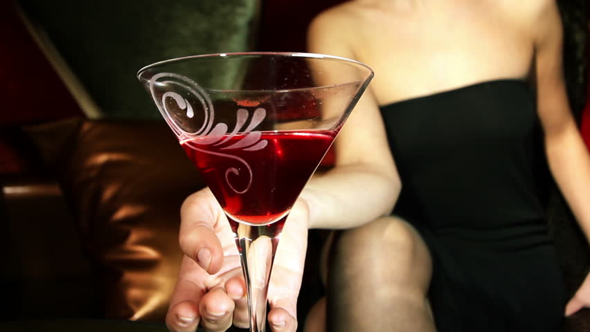 beautiful classic pinup girl in a VIP club drinking a cocktail