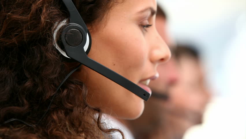 Woman talking on the headset in an office