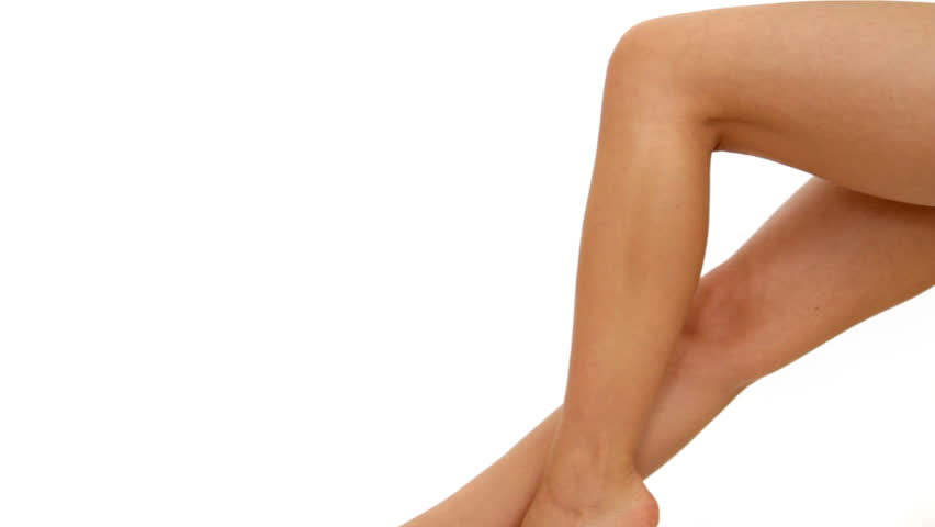 Woman applying moisturizer cream on leg, isolated on white 