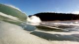 An ocean wave breaking near the shore at Waimea Bay on the island of Oahu, Hawaii.
