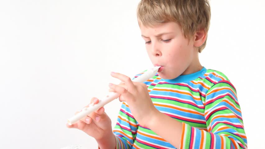 boy plays on wooden pipe on white background