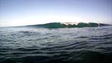 Swimming through the surf and ocean waves on the north shore of Oahu, Hawaii