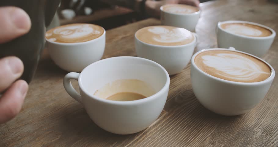 professional barista works in a coffee shop close up draws a barista works