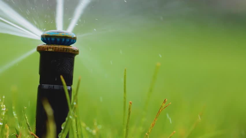 Hd00 15automatic Sprinkler System Watering The Lawn On A