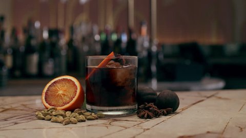 Sherry drink cocktail on an ornate marble topped bar. Medium close shot on a RED camera.