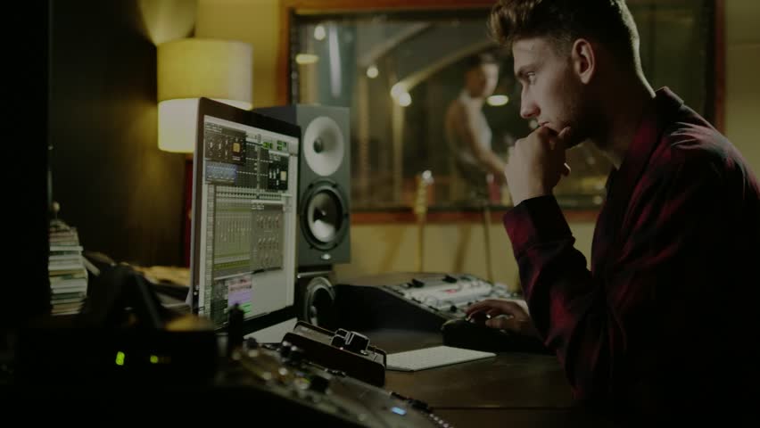 Sound Engineers Working In Garage Recording Studio