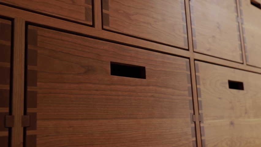 Hand Reaching In To Slide Out A Wooden Drawer Box Slider Shot