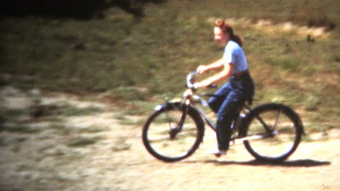 3d Boy Porn - Iowa, usa - june 1949: woman riding bicycle past old car as women started  to gain more roles reserved before for men.