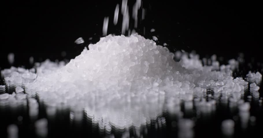 Salt Grain Crystals Falling In Slow Motion On Black Background Stock ...