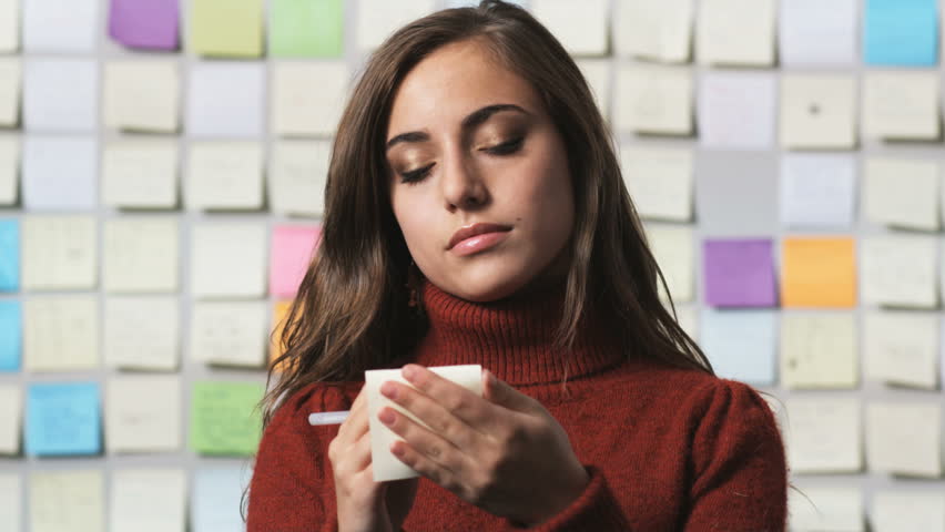 Stock video of woman writing a post it note | 11505461 | Shutterstock