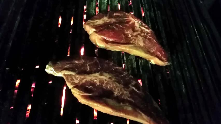 Grilling Black Angus Sirloin Steaks On A Coal Barbeque