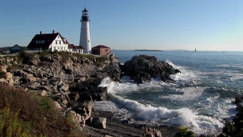 The Portland Head Lighthouse Oversees The Ocean From Rocks In Maine ...