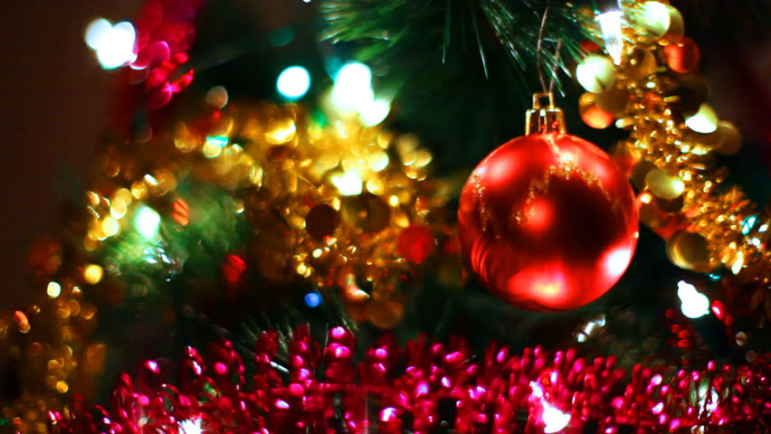 A Red Bauble Ornament Hanging On A Christmas Tree, With Other ...