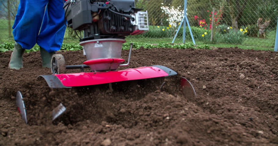 Cultivating Earth With Multikultivator. Person Working On Garden In ...