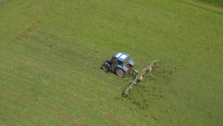 AERIAL: Tractor Mowing On A Grass Field Stock Footage Video 6981640 ...