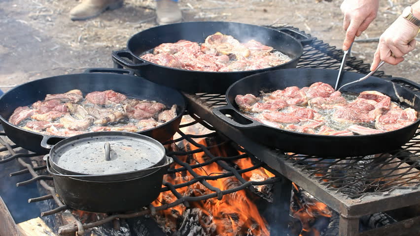 BBQ Lamb And Mutton Steaks And Chops Cooking In Cast Iron Pans Over An ...