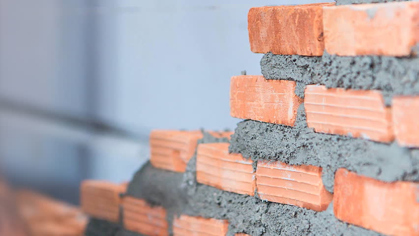 4K. Time lapse construction worker. mason bricklayer installing brick with trowel putty knife