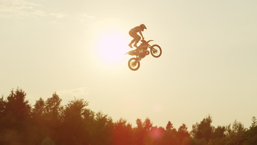 Low Angle Shot Of Motocross Rider Landing After Jump In Slow Motion ...