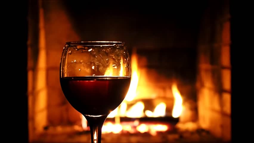 Burning A Fire In The Fireplace Human Hand Takes A Glass Of Wine
