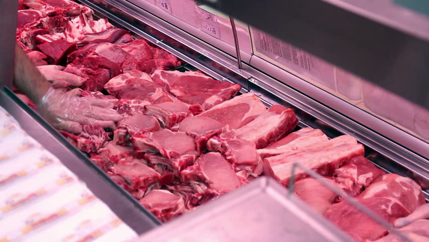 Hd00 16butcher Arranging Meat In Display Case Food Industry