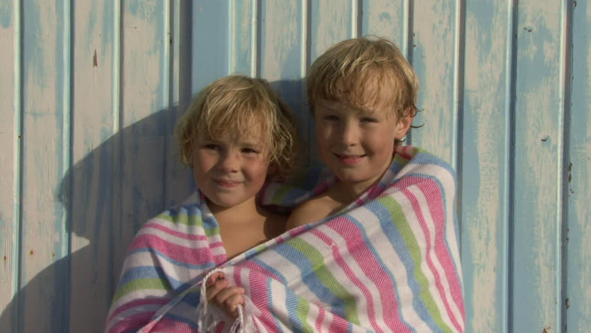 Portrait Of Brother And Sister On Beach Wrapped In Beach Towel Portrait Of Brother And Sister On Beach Wrapped In Beach Towel