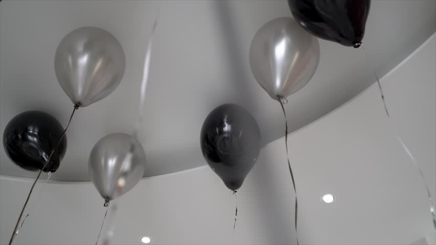 Black And Silver Balloons Fly On The Ceiling