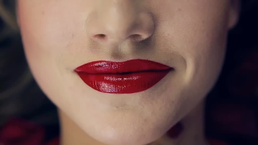 Close-up Of A Girl's Lips With Red Lipstick. Slow Motion. Turns Her 