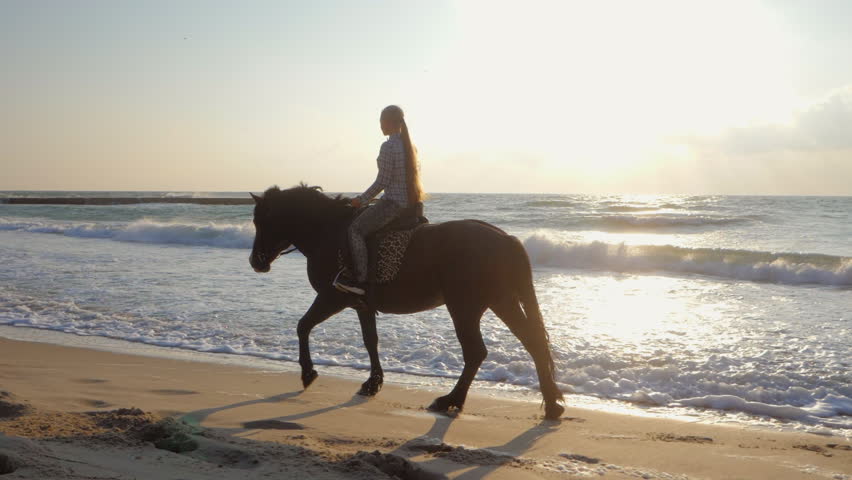 Golden-Haired beauty riding at the beach