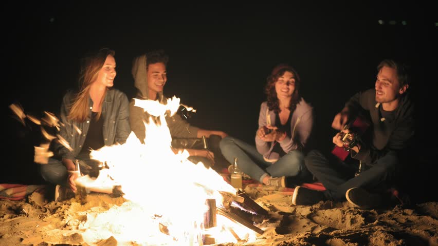 Picnic Of Young People With Bonfire On The Beach In The Evening