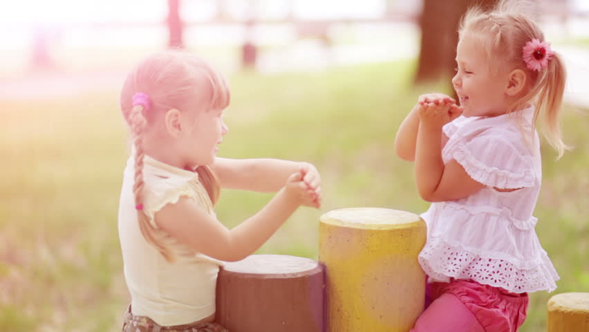Sunny girls outdoors.Children playing in the Kids Count. Slow motion