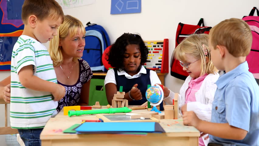 Cute Little Kids Sit In A Group And Listen The Teacher As Patiently As ...