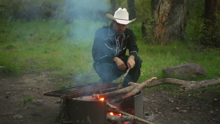 Cowboy Near A Fire Pit Stock Footage Video 100 Royalty Free